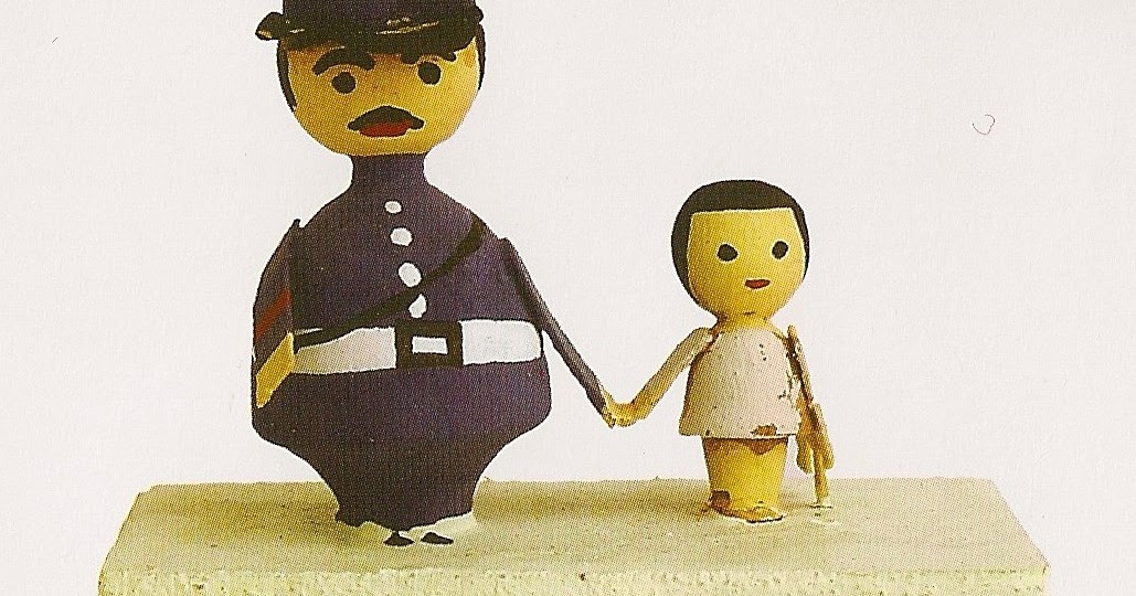 Miniature wooden figure of a policeman holding a child's hand